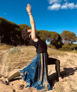 Nina practicing yoga at the beach